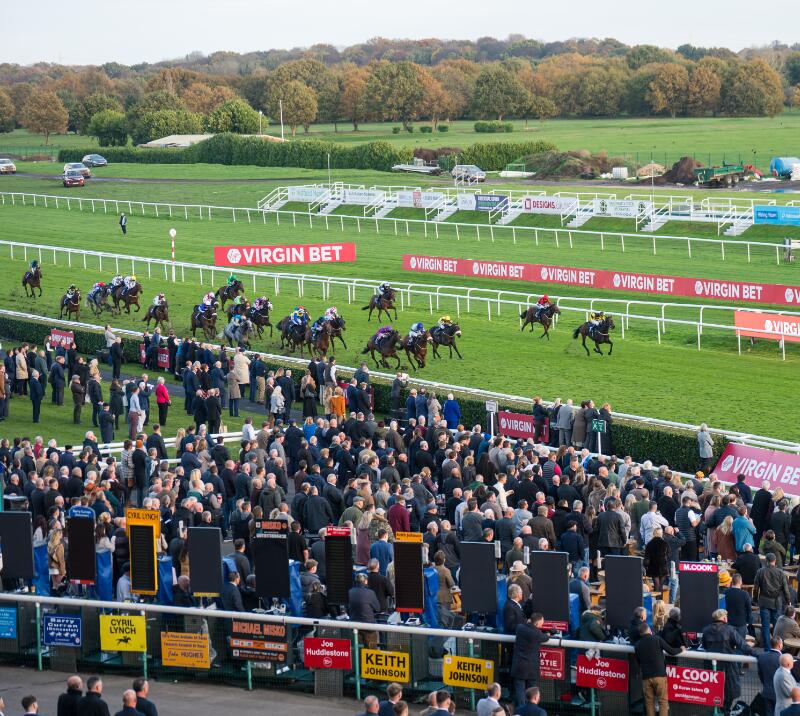 Wide shot of horses running at Doncaster Racecourse 