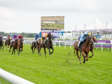 Horses racing towards the finish at Doncaster Racecourse