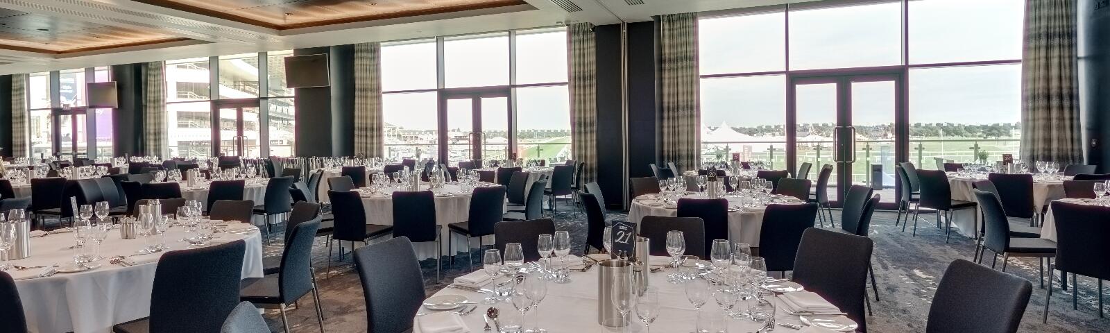 Tables are laid out with glasses and cutlery in the Garden Suite