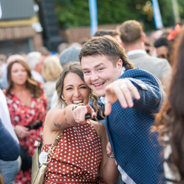 Two people dancing and pointing to the camera on Betfred Gents Day 2025