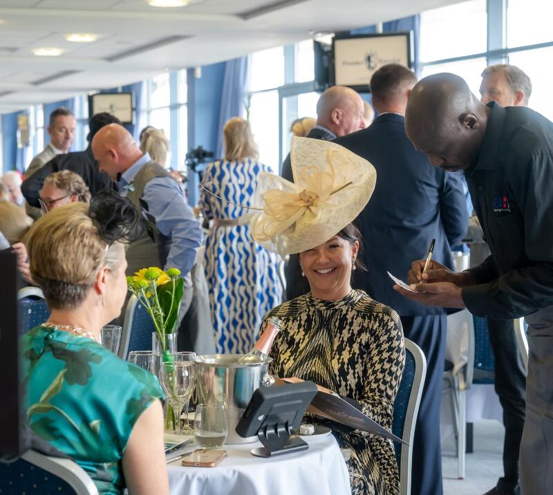 Race goer in a fascinator enjoying hospitality at Doncaster