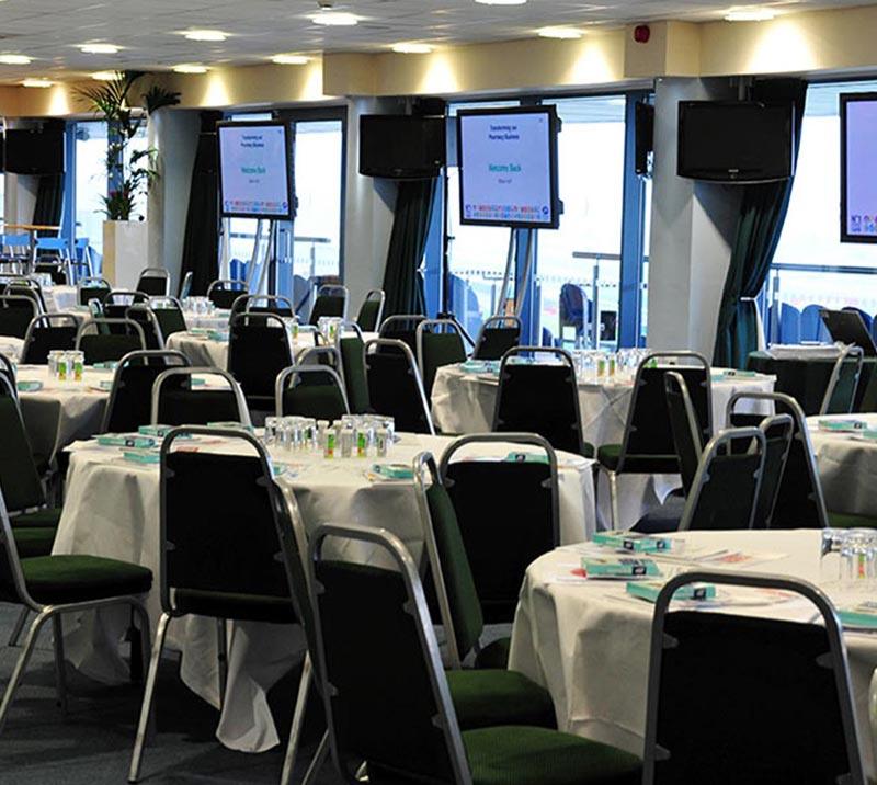 Round tables with chairs all prepared for guests to arrive.