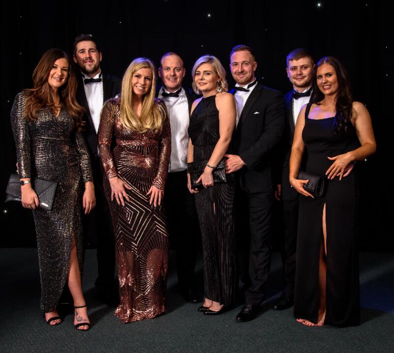 A stylish group of party goers posing for a picture on new years