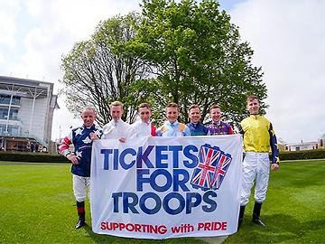 Jockeys Stand with the Tickets For Troops Banner