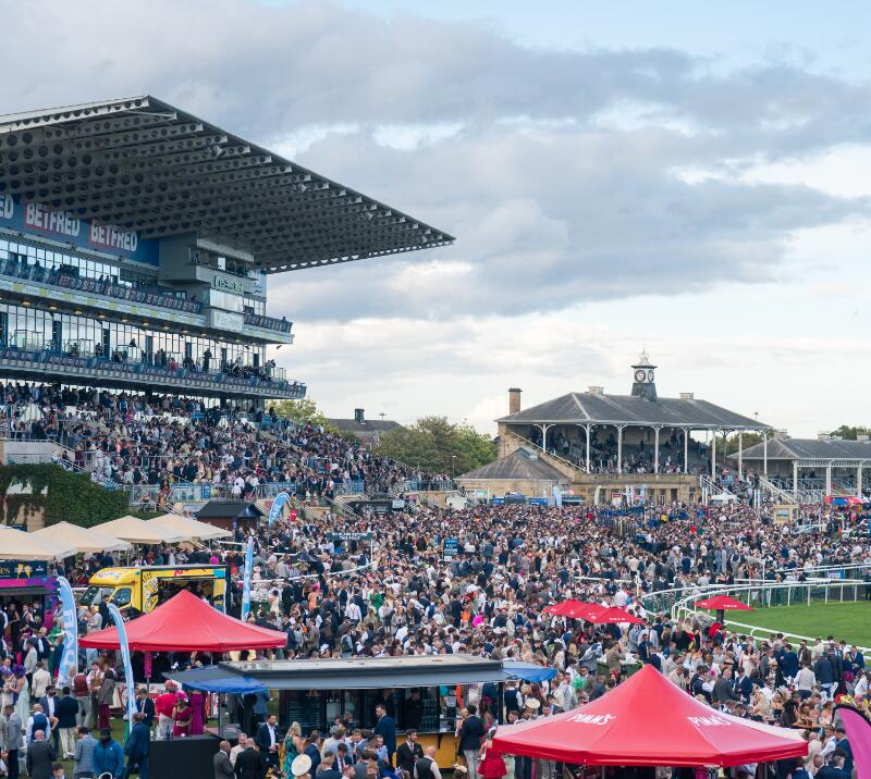Wide shot of Doncaster Racecourse crowd at the Betfred St Leger festival 