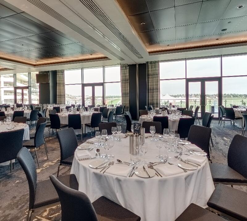 Tables are laid out with glasses and cutlery in the Garden Suite