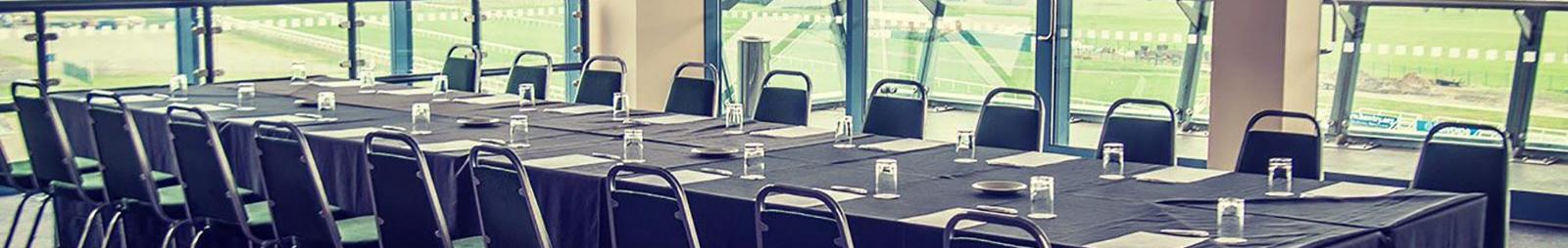 A large rectangular table prepared for a business meeting.