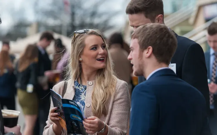 A group of friends study the racecard at Doncaster