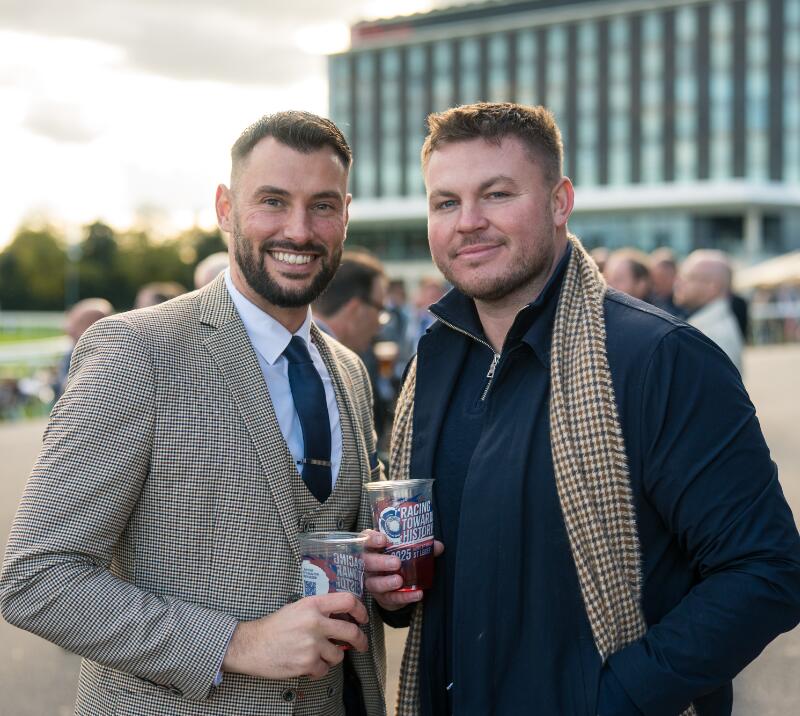 Two men stood with drinks at Doncaster Racecourse