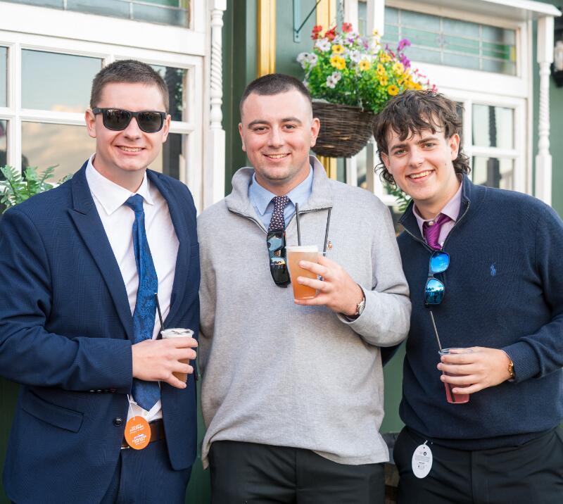 A group of men smiling at Doncaster Cup Day at Doncaster Racecourse 