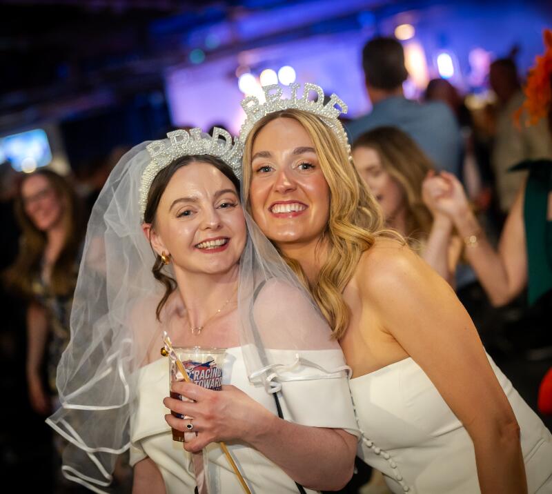 Two women stood with hen do accessories at Doncaster Racecourse 