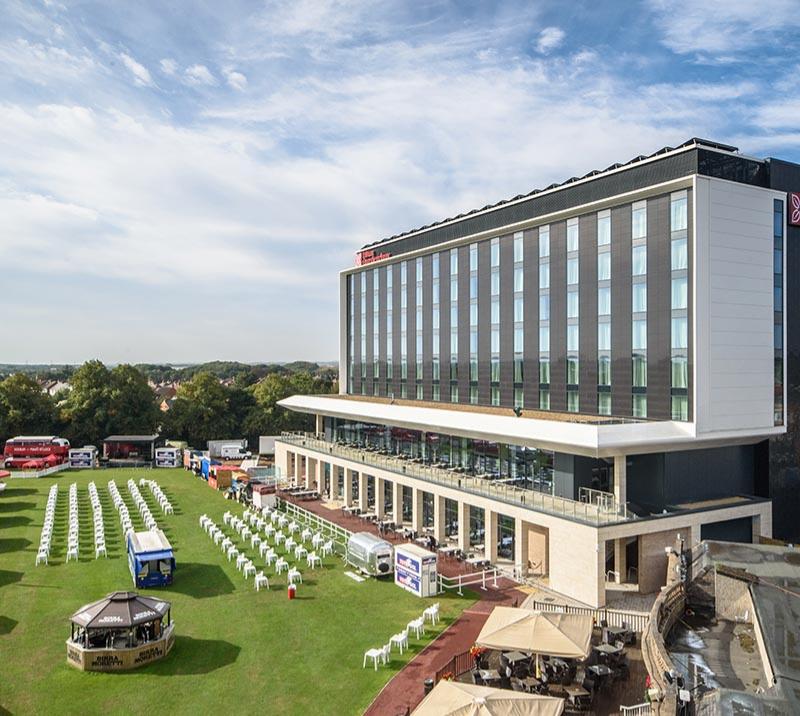 A summertime view of the exterior of the Hilton Garden Inn Hotel at Doncaster Racecourse.