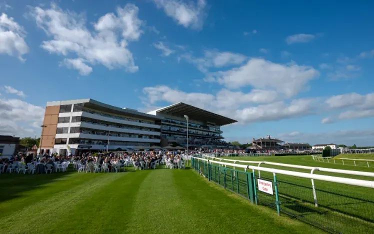 Blue skies behind the packed grandstand at Doncaster Races