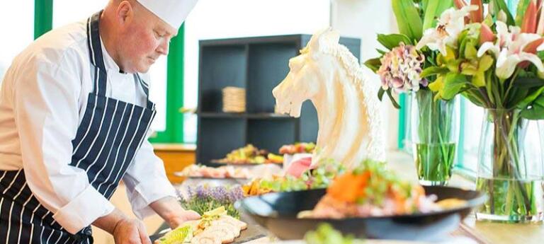 Chef placing food on display.