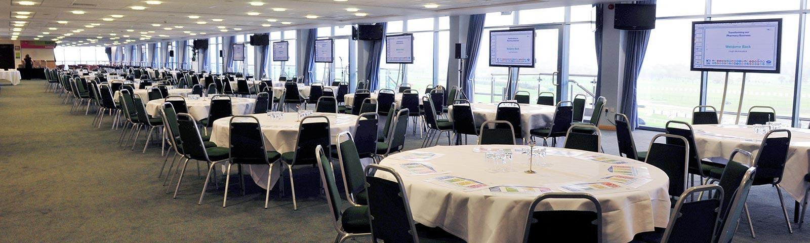 2 rows of tables prepared for guests in the Premier Suite